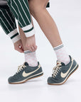 A model wearing pink/white checkered charlie crew socks on a white background.