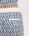 A person standing wearing the Bronson Pant in indigo color, which features a geometric pattern.