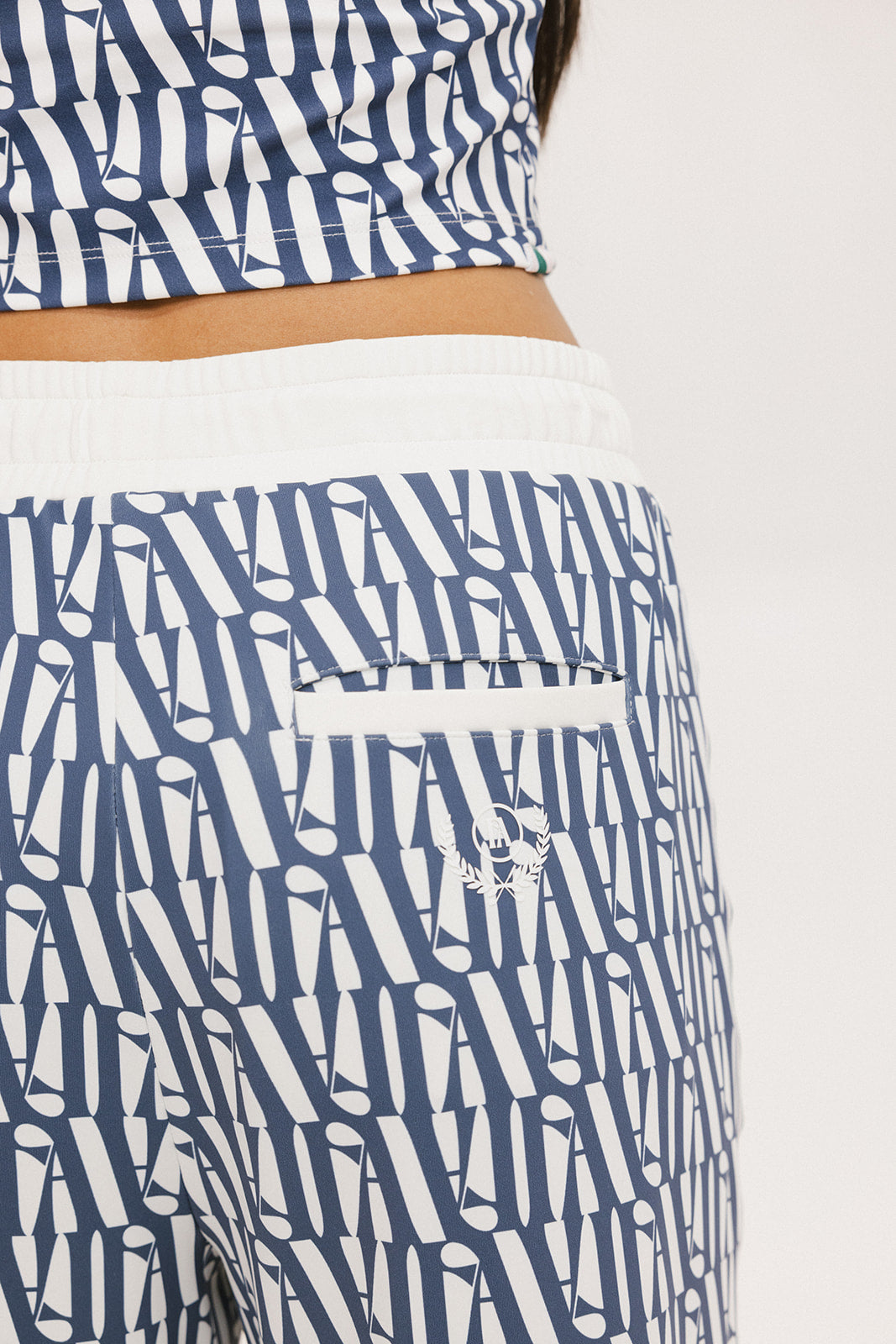 A person standing wearing the Bronson Pant in indigo color, which features a geometric pattern.