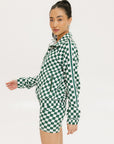 A person wearing green and white checkered biddy shorties and a matching checkered golf jacket, standing against a white background.
