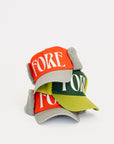 Stack of three caps with 'FORE' and 'FORE' text on a white background