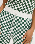A pair of green checkered pants with a relaxed fit and pockets.
