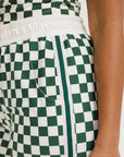 A pair of green checkered pants with a relaxed fit and pockets.