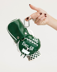 Green golf club head cover with 'Fore All' text held by a hand on a white background