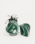 Green golf bag with golf clubs and a green visor on a white background