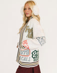 Woman wearing a patterned cardigan with text and graphics on a white background