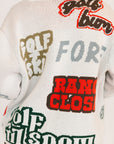 Close-up of a sweater with text and brand logos on the back