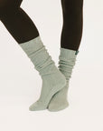 Light gray socks worn with black leggings on a white background