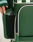 Green checkered bag with a hand holding it, on a light background