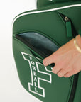 Green golf bag with 'FORE ALL' text on a white background