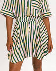 Striped skirt with green, yellow, and white pattern on a plain background