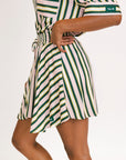 Striped skirt with green, yellow, and white pattern on a plain background
