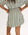 Striped skirt with green, yellow, and white pattern on a plain background