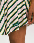 Close-up of a striped garment with a brand label on a neutral background