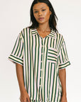 Woman wearing a green and white striped shirt on a white background