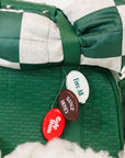 Green and white checkered blanket with golf-themed buttons on a white background