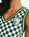 Green and white checkered jersey with a logo on a person
