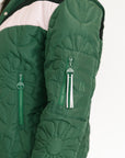 Close-up of a green quilted jacket with floral patterns on a white background