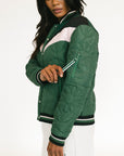 Person wearing a green and white quilted jacket on a white background