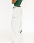 White wide-leg pants with green accents on a white background