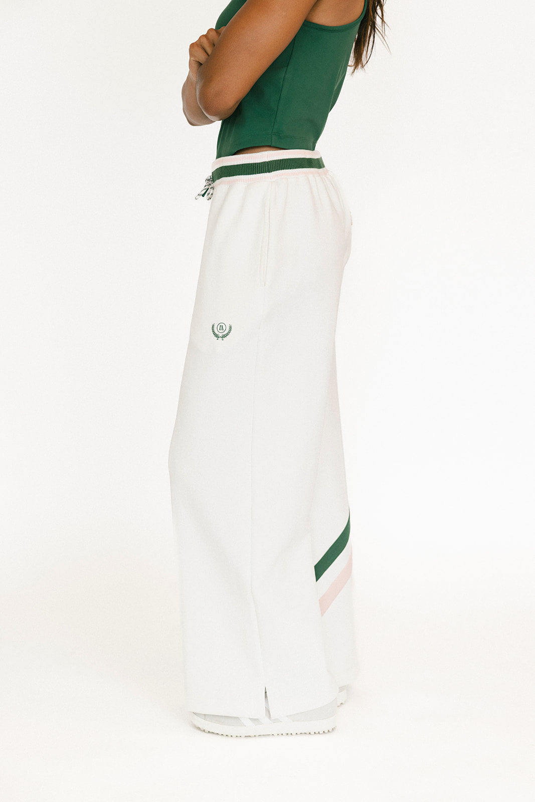 White wide-leg pants with green accents on a white background