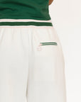 White pants with green trim on a white background