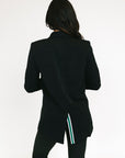 Person wearing a black blazer with a white background