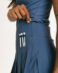 Blue skirt with a pocket containing golf tees on a white background