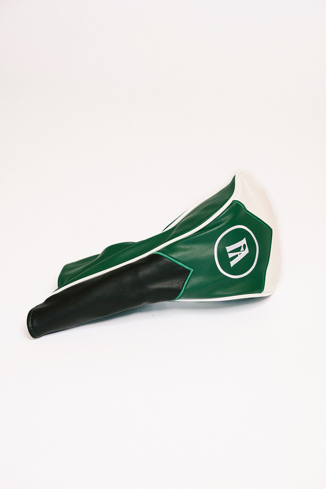 Green and black golf club head cover on a white background