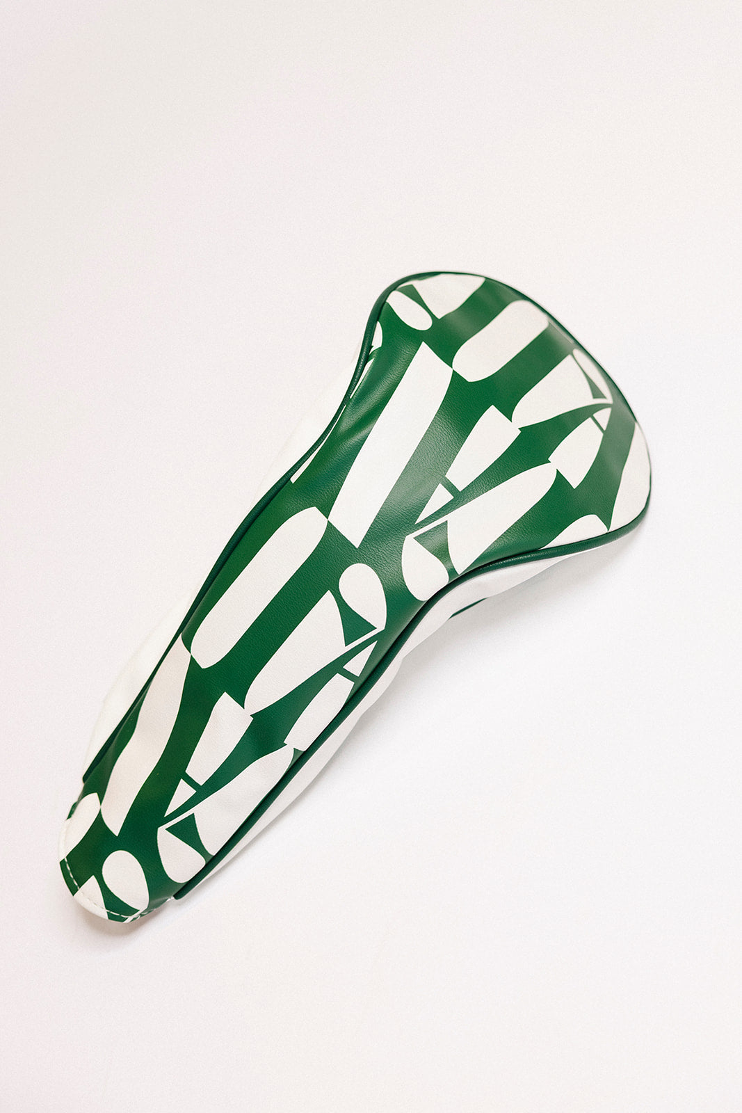 Green and white golf headcover on a white background.