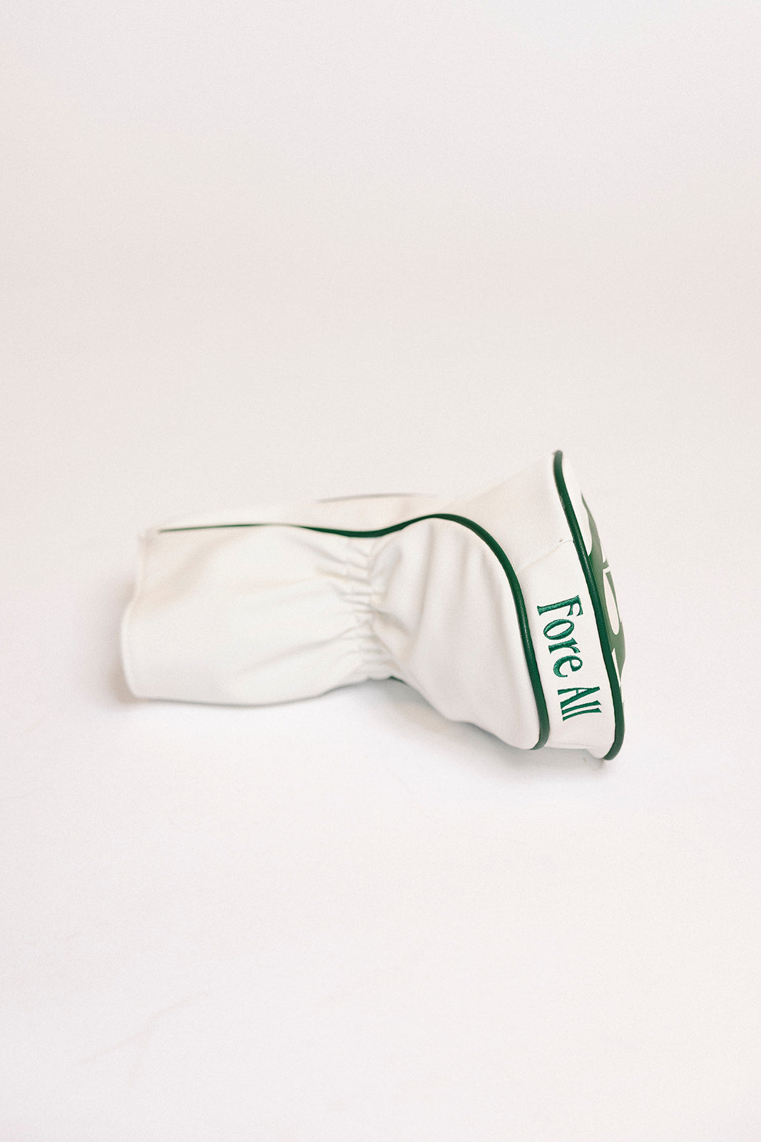 White golf club head cover with green text on a white background