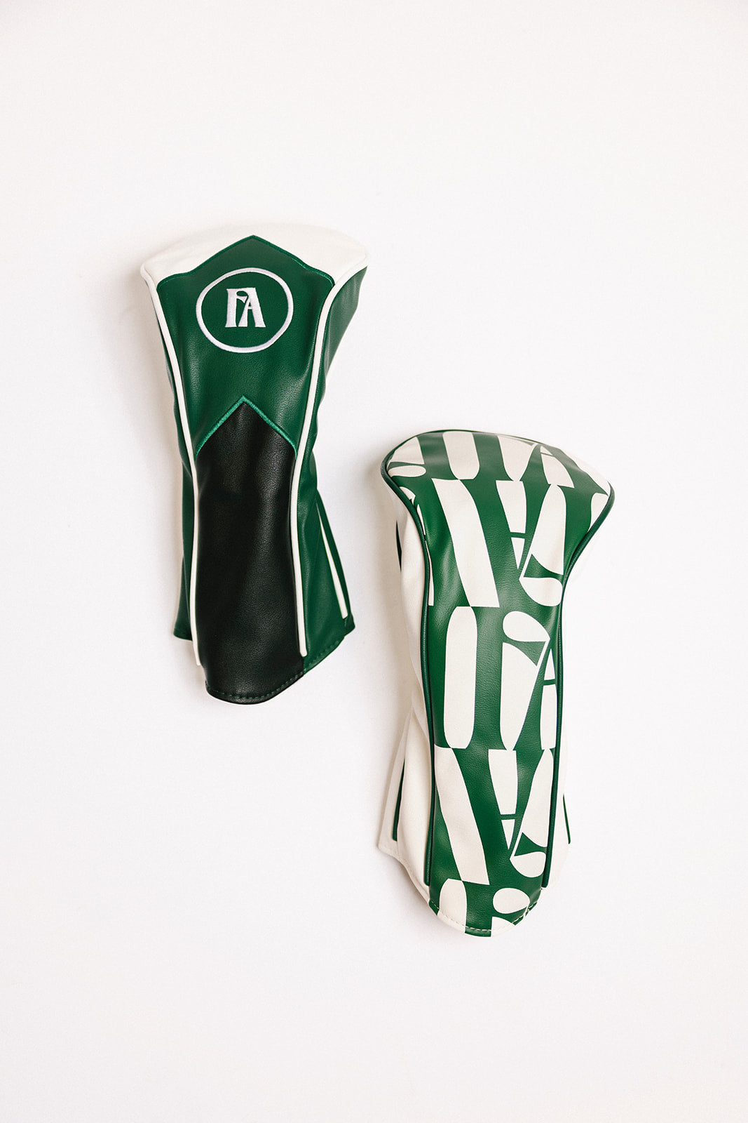 Two golf club heads with green and white design on a white background