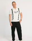 A man wearing a beige zip sweater with vertical green stripes and the text 'Fore All x Khalhon' on the chest.