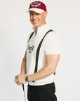 A man wearing a beige zip sweater with vertical green stripes and the text 'Fore All x Khalhon' on the chest.