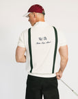 A man wearing a beige zip sweater with vertical green stripes and the text 'Fore All x Khalhon' on the chest.