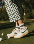 A model wearing a pink and green striped retro ankle sock.