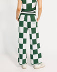 Person wearing a green and white checkered outfit on a white background