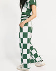 Person wearing a green and white checkered outfit on a white background