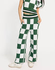 Person wearing a green and white checkered outfit on a white background