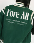 Green varsity jacket with 'Fore All' text on the back