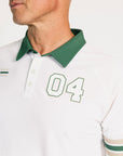White polo shirt with green collar and sleeve stripes, featuring the number '04'.