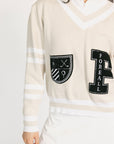 Cream-colored sweater with black emblem and 'Foreall' text on a white background