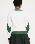 Woman wearing a green and white sweater with 'FORE' text on a plain background