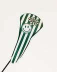 Green and white striped golf club head cover with smiley face and flower design on a white background