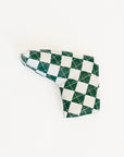 Checkered green and white golf club head cover on a white background