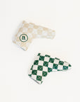 Two checkered golf club covers on a white background