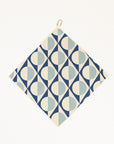 Golf towel with geometric pattern hanging on a white background