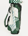 Green golf bag with a towel draped over it on a white background