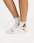 'A' logo on white socks on a light background