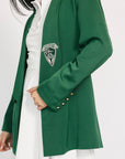 Green blazer with a logo worn by a person on a white background
